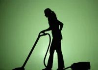 Silhouette of a person vacuuming
