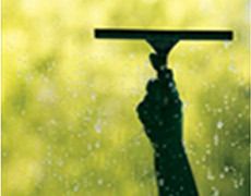 Worker using a squeegee for window cleaning