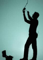 Silhouette of a worker on a ladder
