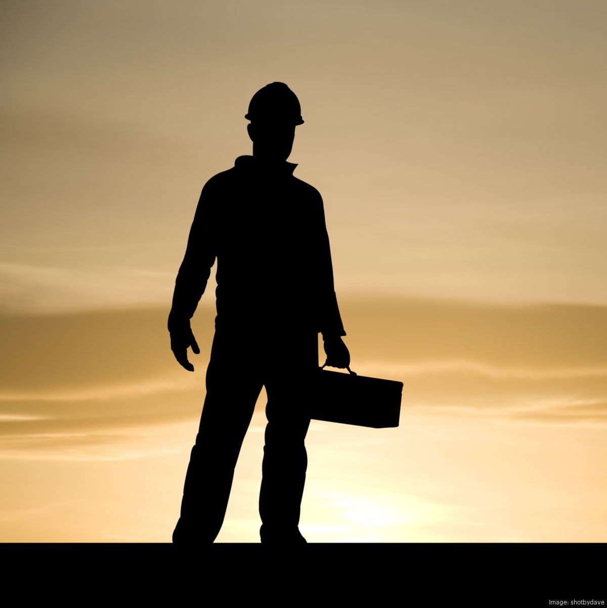 Silhouette of a worker performing outdoor maintenance